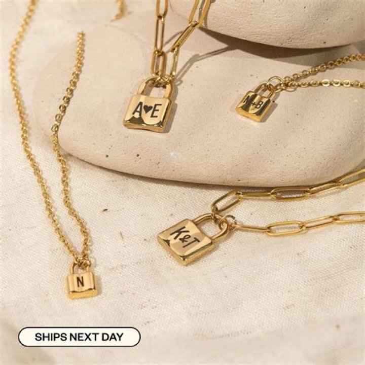 An initial necklace, a toiletry bag, a face shield and bestselling candles