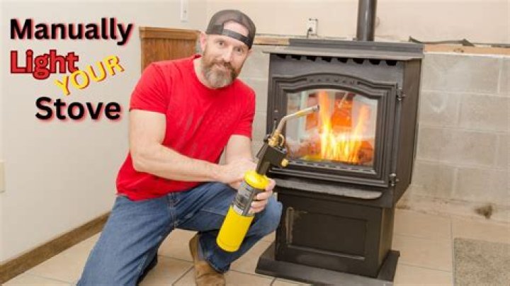 How do you manually ignite a pellet stove?